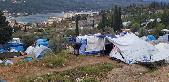 Migrants living in self-purchased tents in front of the overcrowded hotspot in Samos