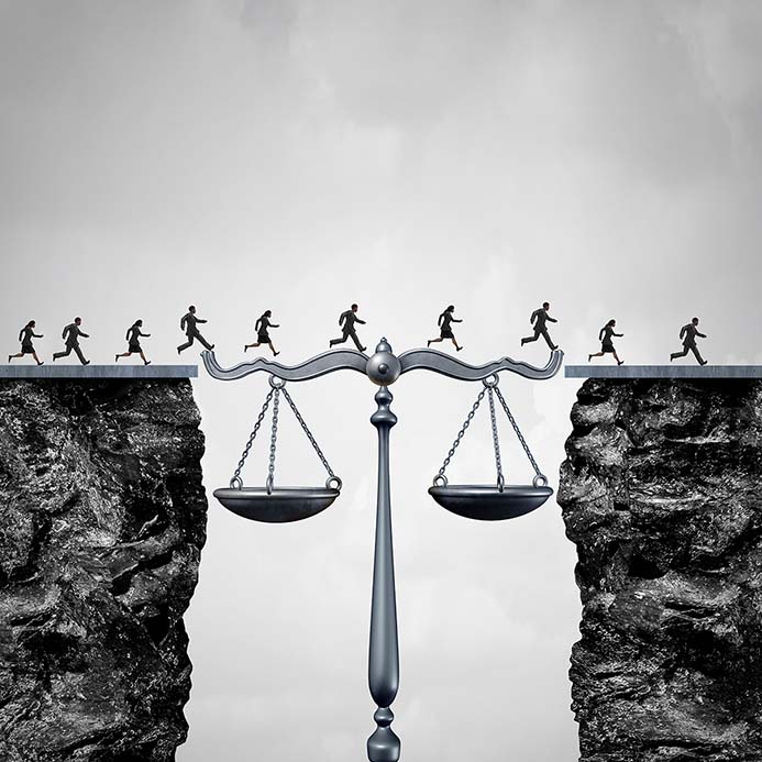 People walking across a gap bridged by the scales of justice