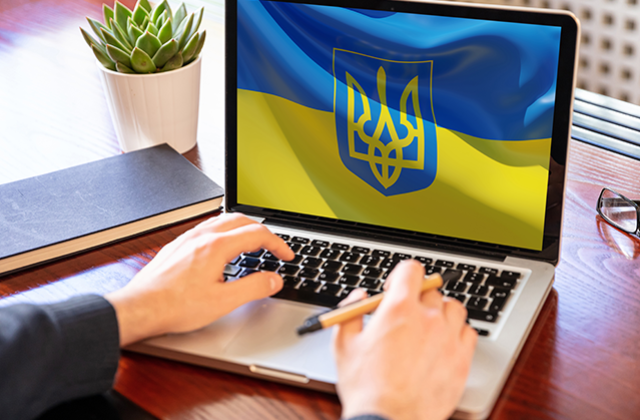 Support Ukraine, donate help Ukrainian people. Flag on computer laptop screen.