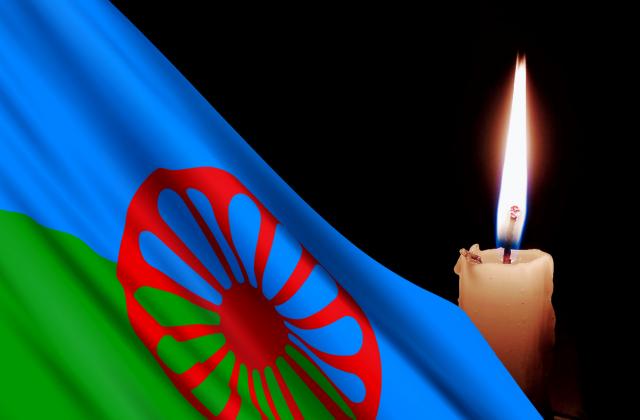 Roma flag against a burning candle