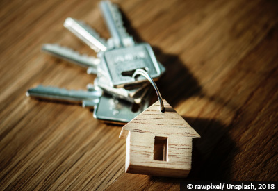 Wooden carving of a house on a key ring with keys