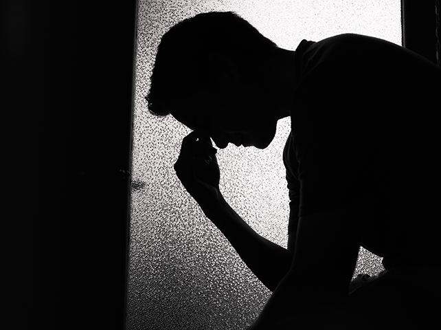 Sad young man in a dark room