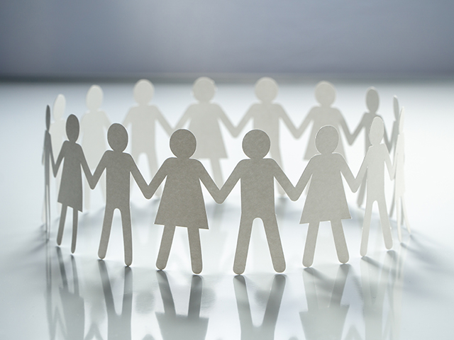 cutout figures holding hands.
