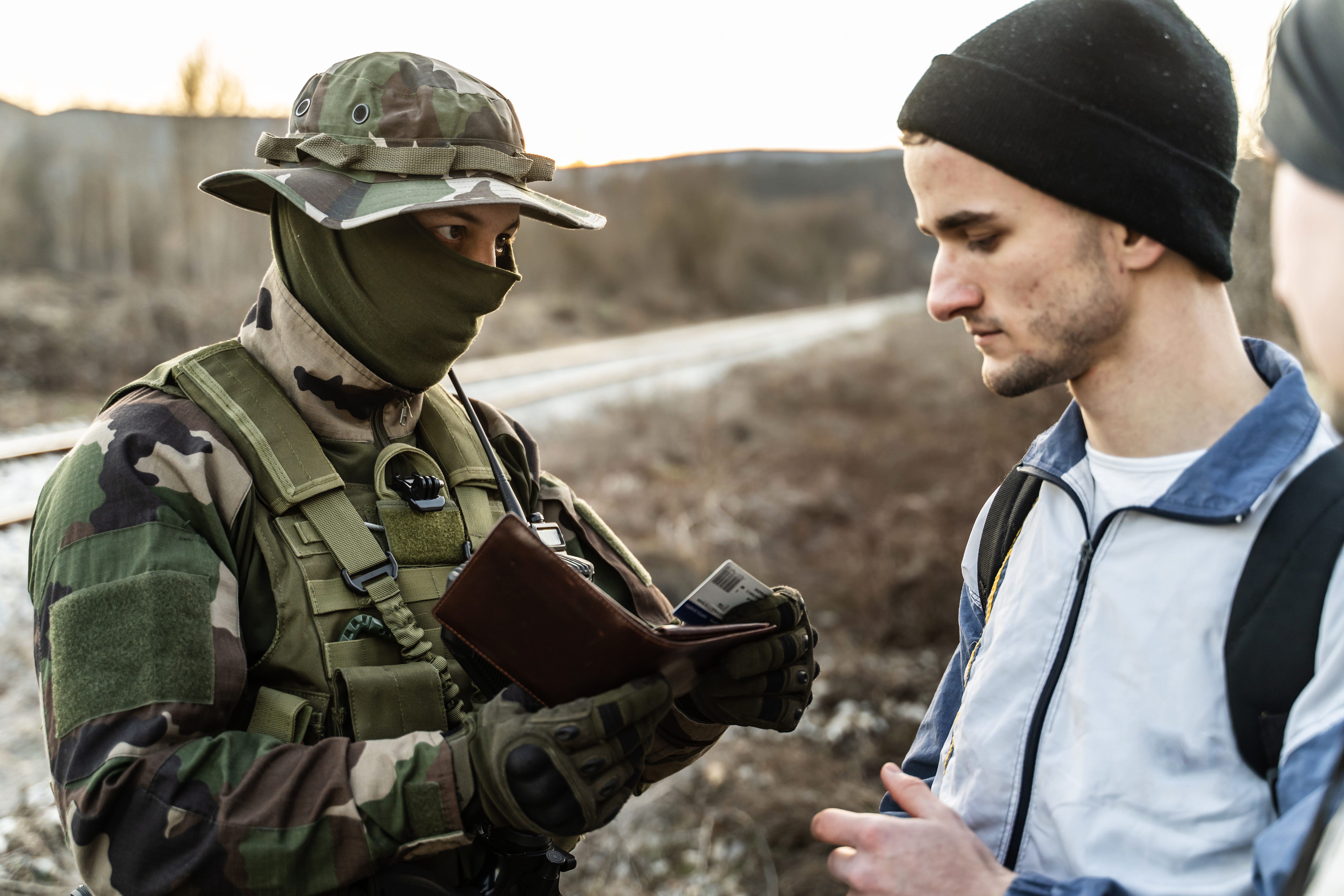Border official checks a migrant's ID