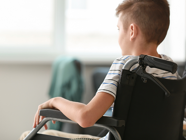 Boy in wheelchair at home 