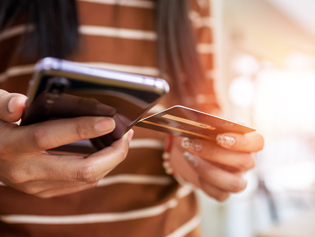 Close up young woman hands holding credit card