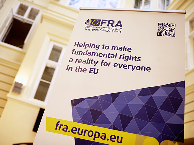 FRA rollup banner inside the premises saying Helping to make fundamental rights a reality for everyone in the EU