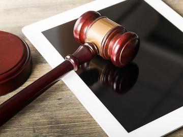 Gavel against a tablet