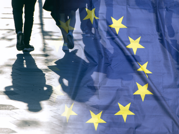 2 people walking with EU flag superimposed.