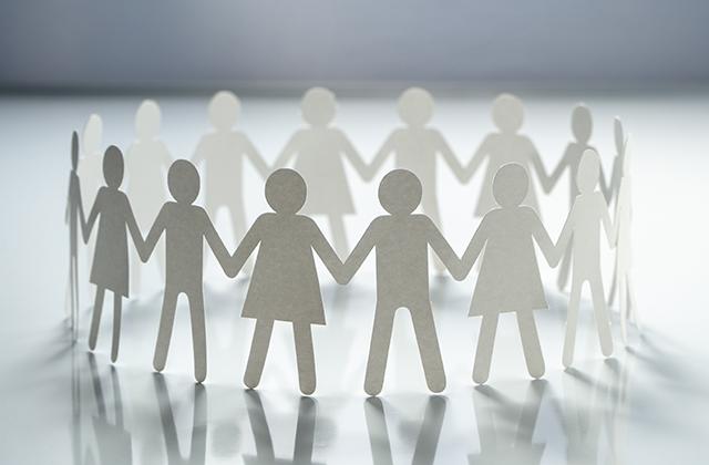 cutout figures holding hands.