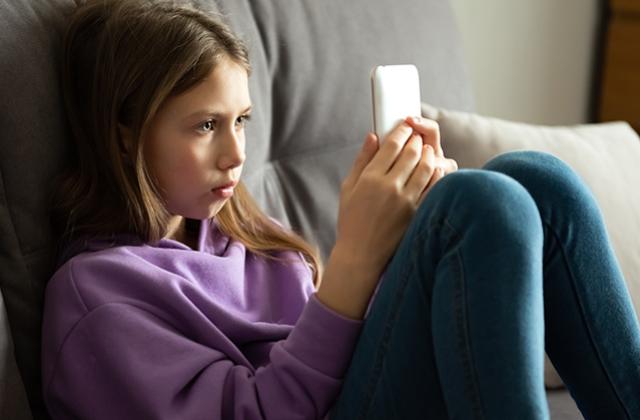 Girl using phone at home