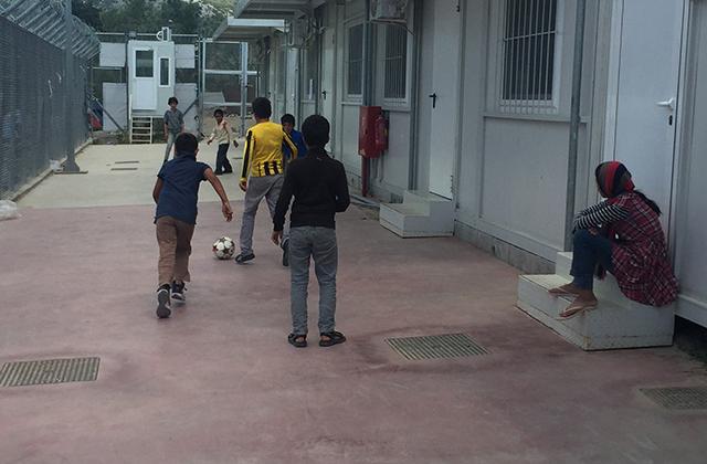 Children playing football in a reception centre