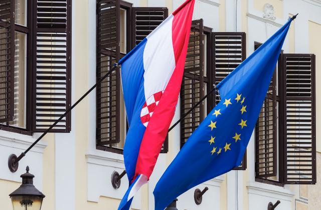 EU and Croatian flags on a building