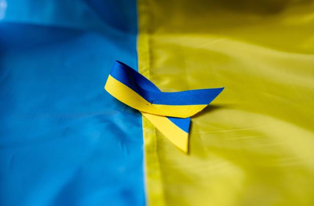 Ukrainian flag with ribbon of solidarity.