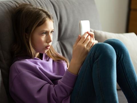 Girl using phone at home