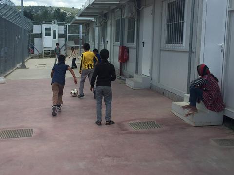 Children playing football in a reception centre